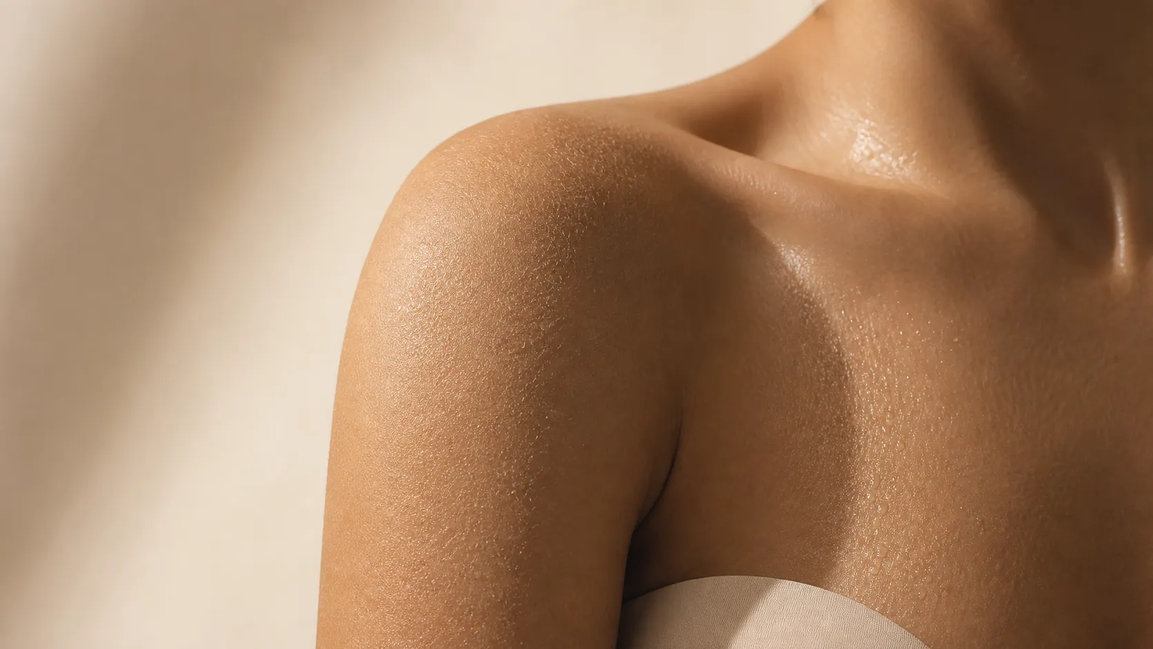 Woman's body skin in warm light showing the difference between dry and dehydrated body skin